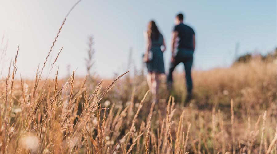 Couple in wheat field shows the concept of couples therapy for addiction being covered by insurance