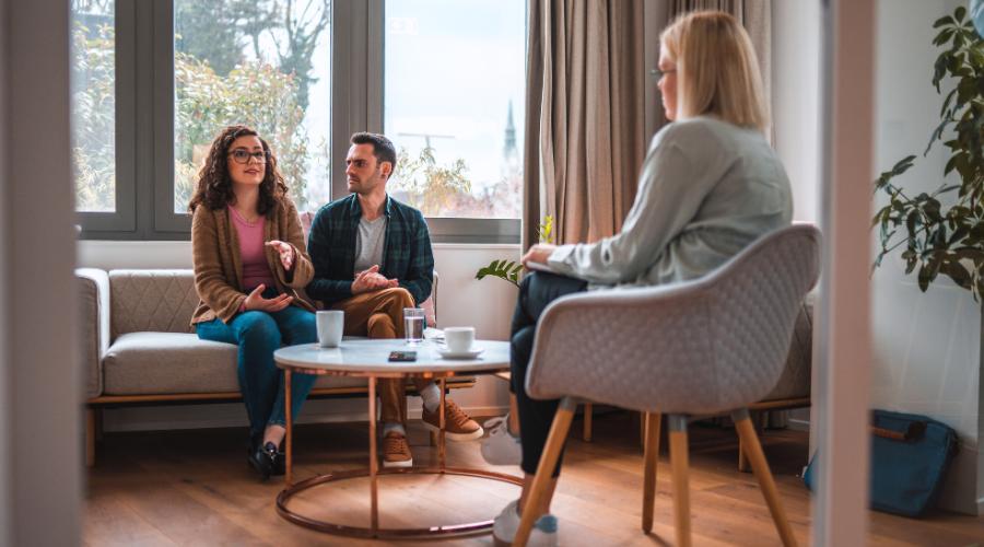 Is couples therapy covered by insurance concept pic shows a man and woman speaking to their therapist